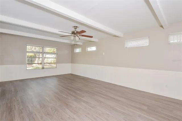 wooden floor in an empty room with a window