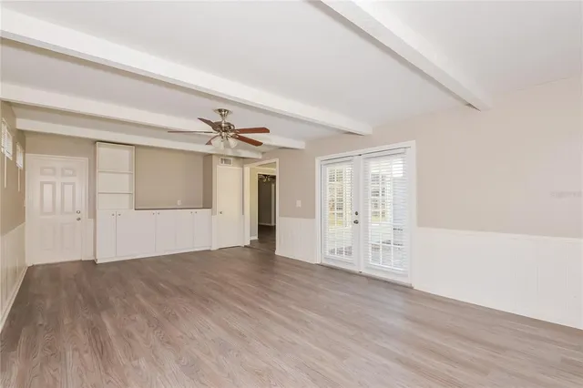 wooden floor in an empty room with a window