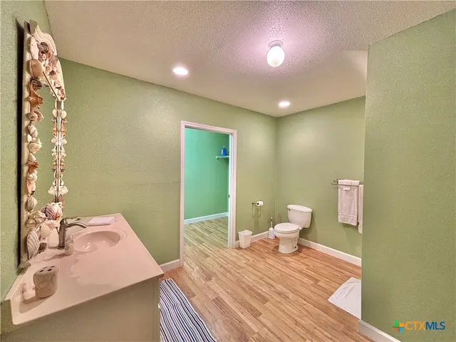 a bedroom with a bed and a lamp with the wooden floor