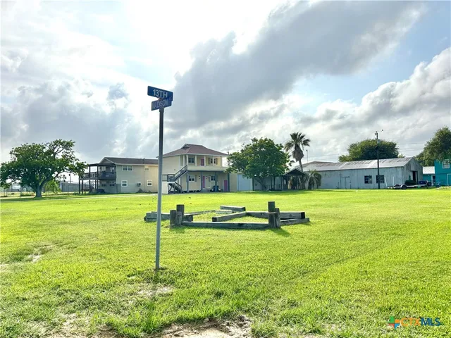 a view of a garden with lawn chairs