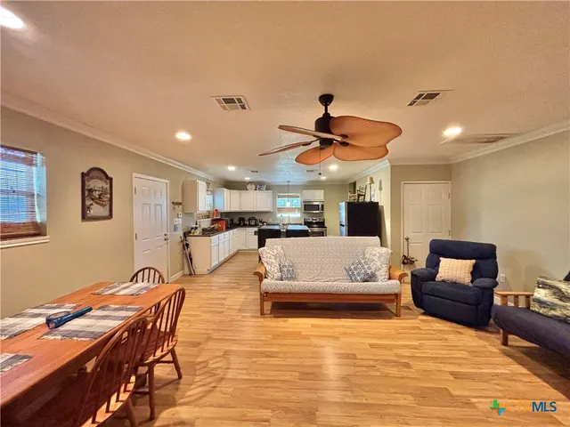 a living room with furniture and a ceiling fan