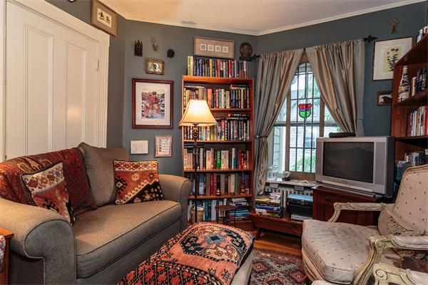 151 Appleton Street Cambridge, MA 02138 - Photo 6 of 15 a living room with furniture a bookshelf and a window