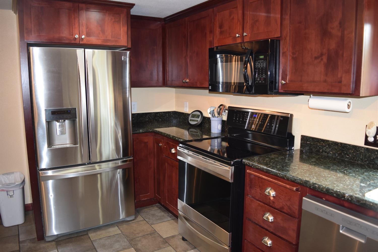 847 Big Bend Road Roseburg, OR 97471 - Photo 10 of 25 a kitchen with granite countertop stainless steel appliances and wooden cabinets