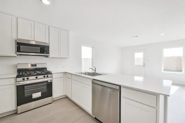 a kitchen with a sink and cabinets