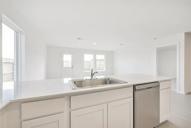 a kitchen with microwave a stove and cabinets