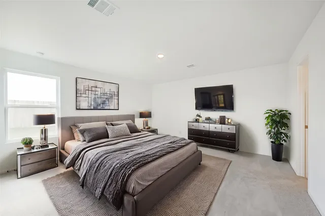 a bedroom with a bed and a flat screen tv