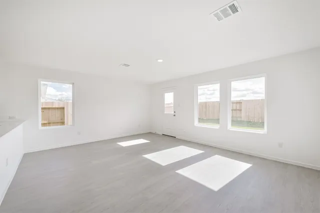 a view of a kitchen with a sink and a refrigerator
