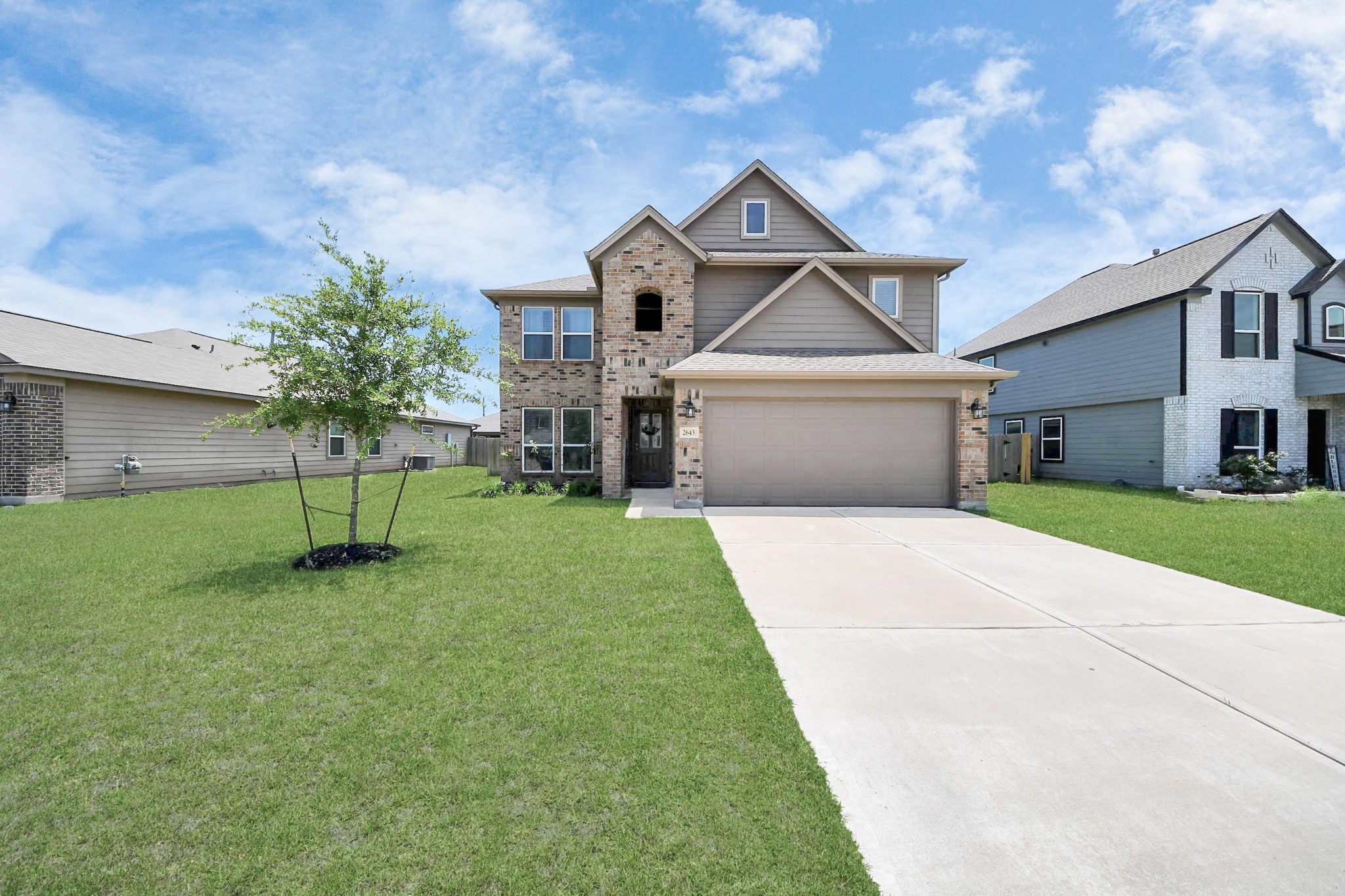 2643 Ridgeback Drive Rosenberg, TX 77471 - Photo 4 of 46 a front view of a house with a yard and a garden