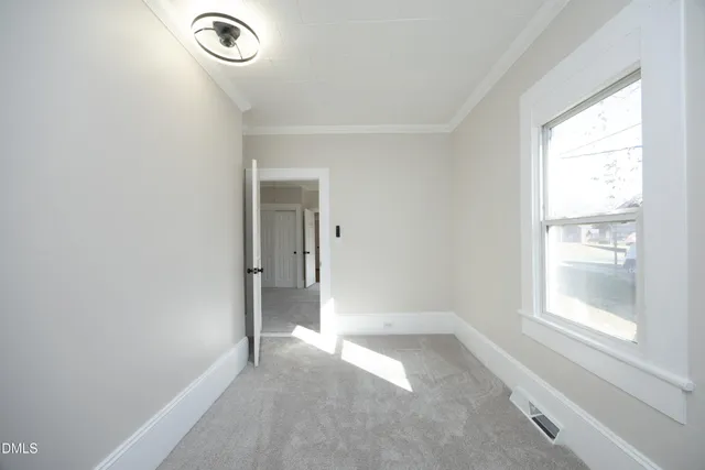 an empty room with a empty space and windows