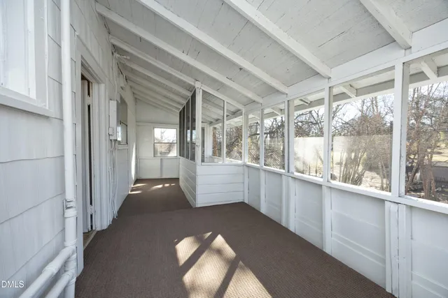a view of a house with a yard covered with snow in the road
