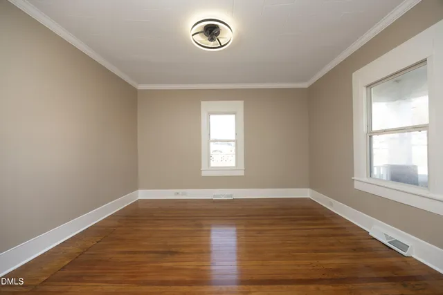 a view of a room with wooden floor and window