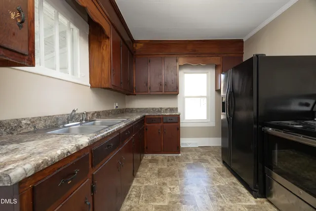 a kitchen with granite countertop stainless steel appliances and wooden cabinets