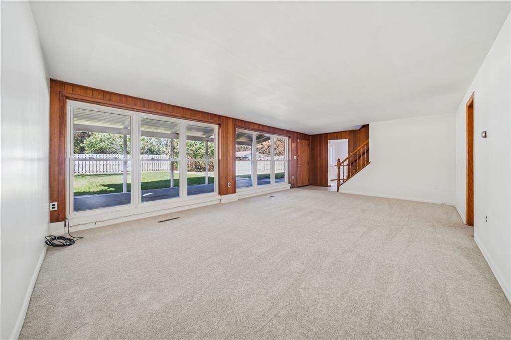 1135 Harvard Road Monroeville, PA 15146 - Photo 5 of 35 Spacious living room featuring large windows that provide beautiful views of the flat, private backyard.
