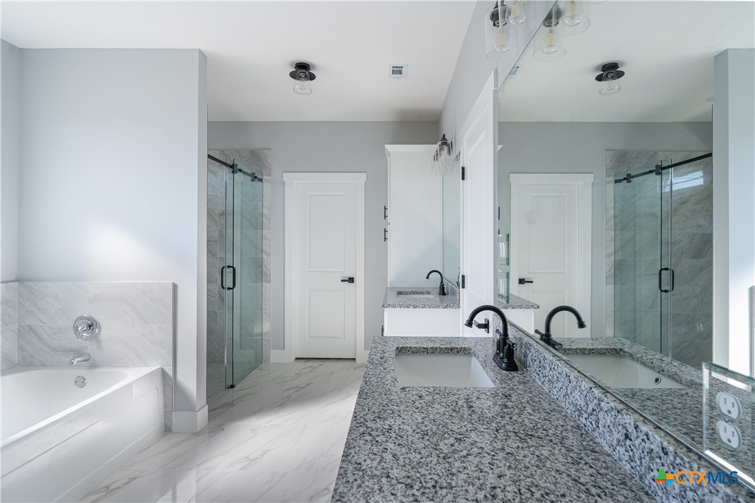 1000 Black Ankle Road Lockhart, TX 78644 - Photo 16 of 40 a spacious bathroom with a bathtub and a shower