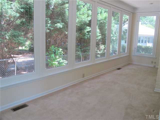 307 Perry Street Raleigh, NC 27608 - Photo 7 of 11 Sun room with a wall of windows with tons of natural light throughout, presents a comfortable setting for all seasons. Sun Room