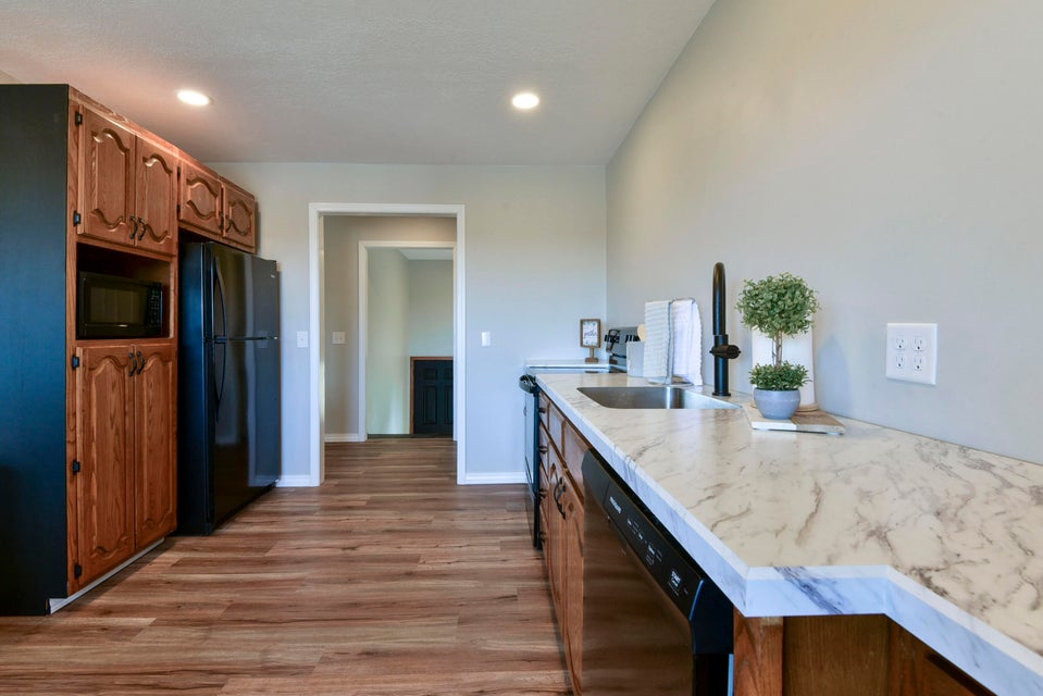 Kitchen featuring wood-finish flooring and recessed lighting