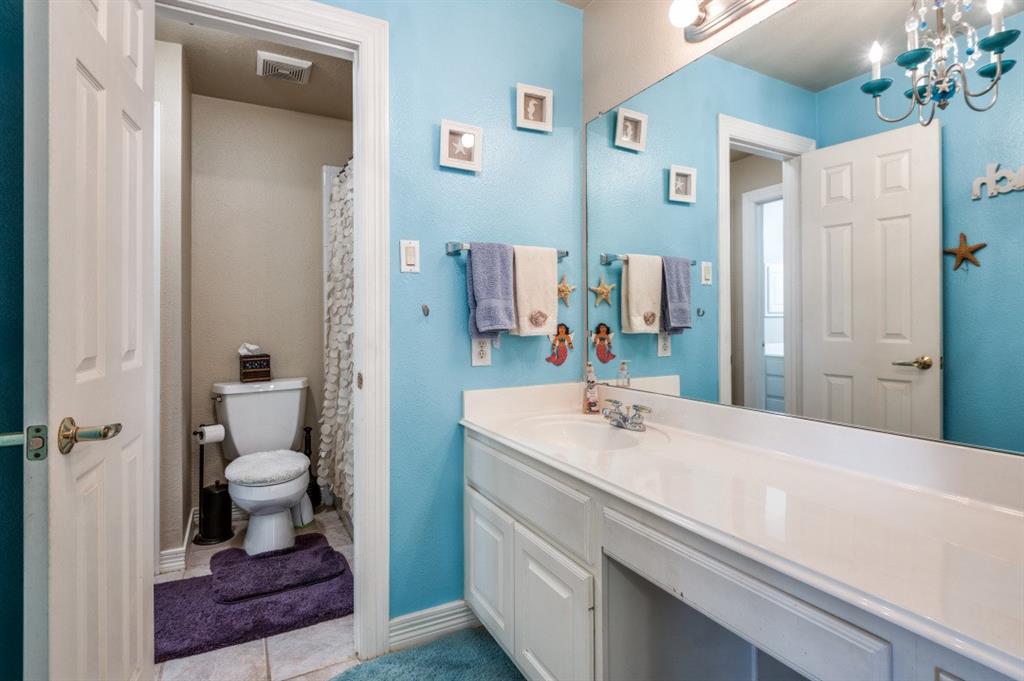 707 Bent Tree Court Coppell, TX 75019 - Photo 12 of 39 a bathroom with a sink and a mirror