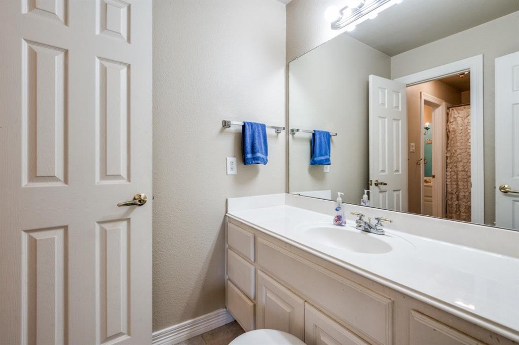 707 Bent Tree Court Coppell, TX 75019 - Photo 16 of 39 a bathroom with a sink and a mirror