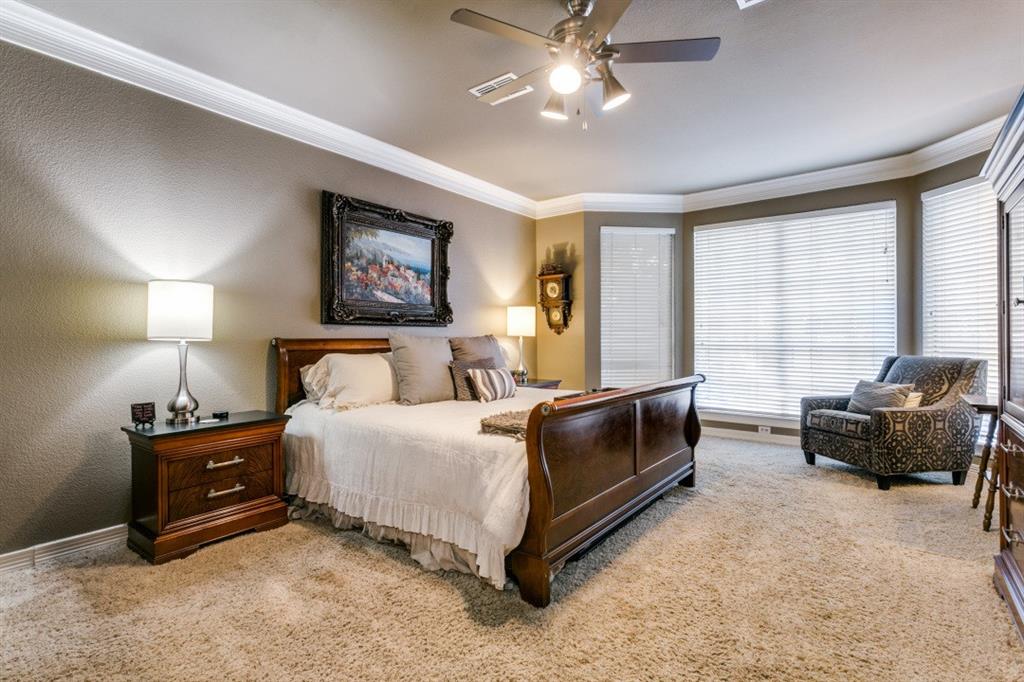 707 Bent Tree Court Coppell, TX 75019 - Photo 2 of 39 a spacious bedroom with a bed and a couch