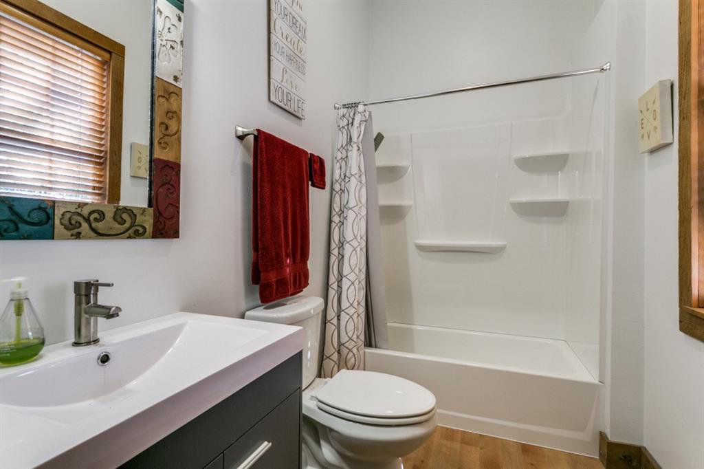 707 Bent Tree Court Coppell, TX 75019 - Photo 20 of 39 a bathroom with a sink a toilet and shower