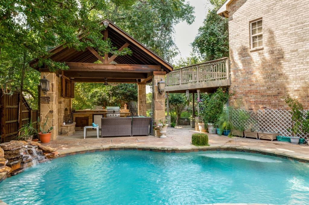 707 Bent Tree Court Coppell, TX 75019 - Photo 35 of 39 a patio with table and chairs and potted plants