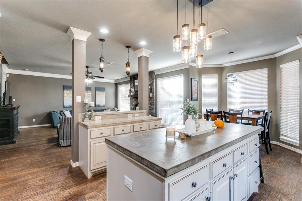 707 Bent Tree Court Coppell, TX 75019 - Photo 39 of 39 a room with stainless steel appliances kitchen island granite countertop a table chairs and a refrigerator