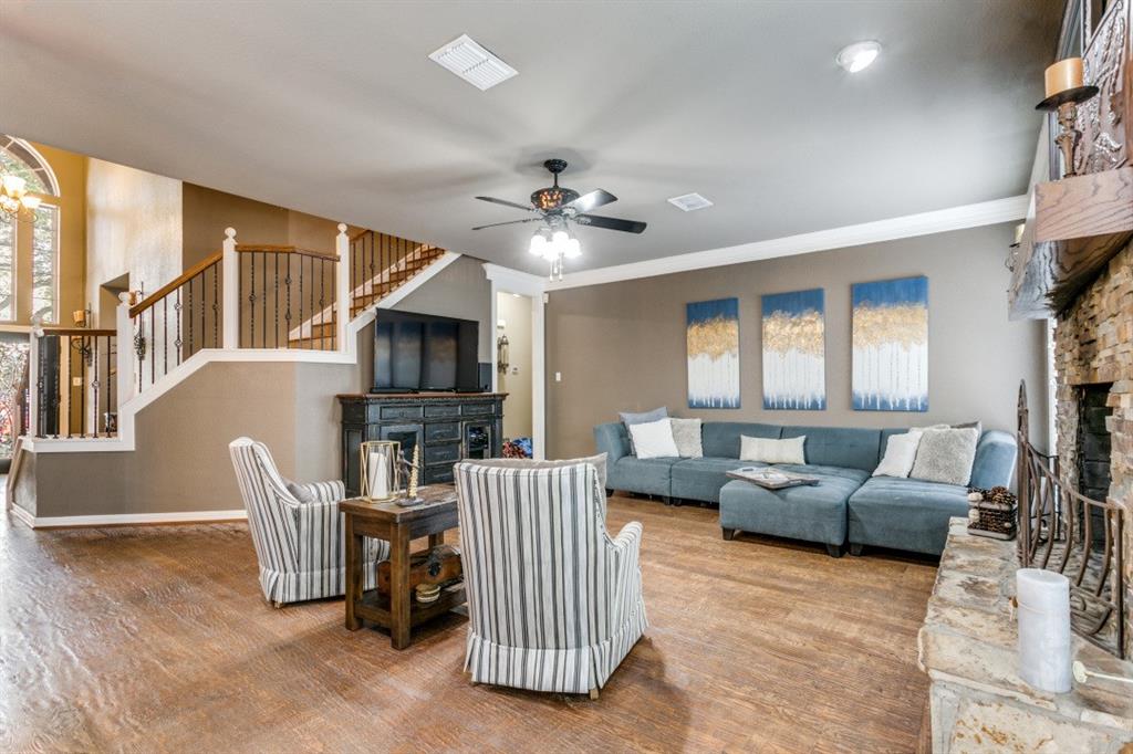 707 Bent Tree Court Coppell, TX 75019 - Photo 8 of 39 a living room with furniture a fireplace and a flat screen tv