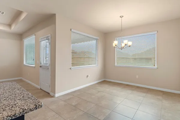 a bathroom with a granite countertop sink a mirror and a bathtub