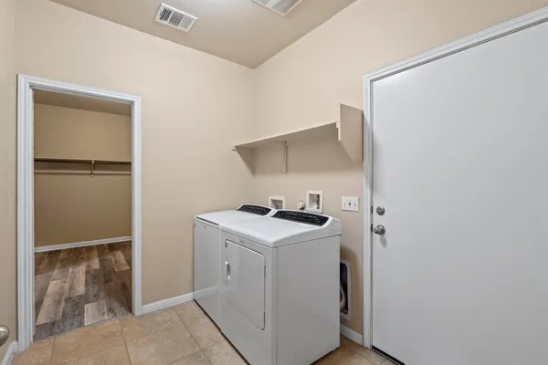 a utility room with sink dryer and washer