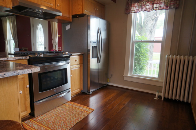 3-s015 Dauberman Road Elburn, IL 60119 - Photo 4 of 15 a kitchen with granite countertop wooden floors and stainless steel appliances