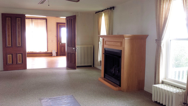 3-s015 Dauberman Road Elburn, IL 60119 - Photo 6 of 15 a view of an empty room with a fireplace and a window