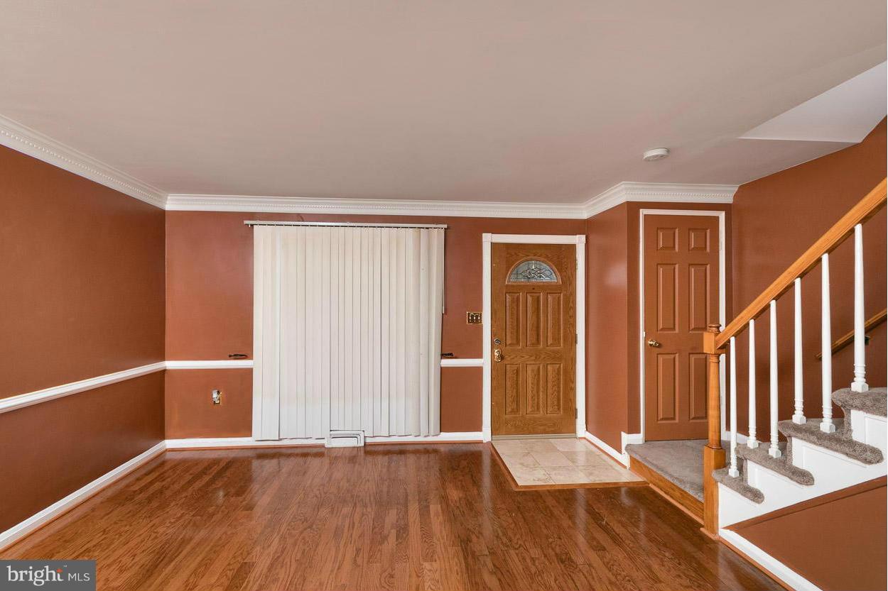 573 Brisbane Road Baltimore, MD 21229 - Photo 12 of 30 wooden floor in an empty room with a window