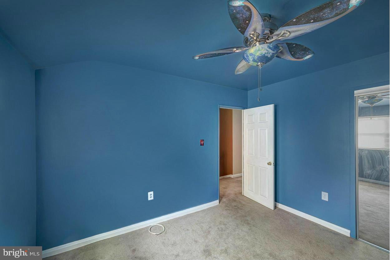 573 Brisbane Road Baltimore, MD 21229 - Photo 18 of 30 an empty room with a chandelier fan