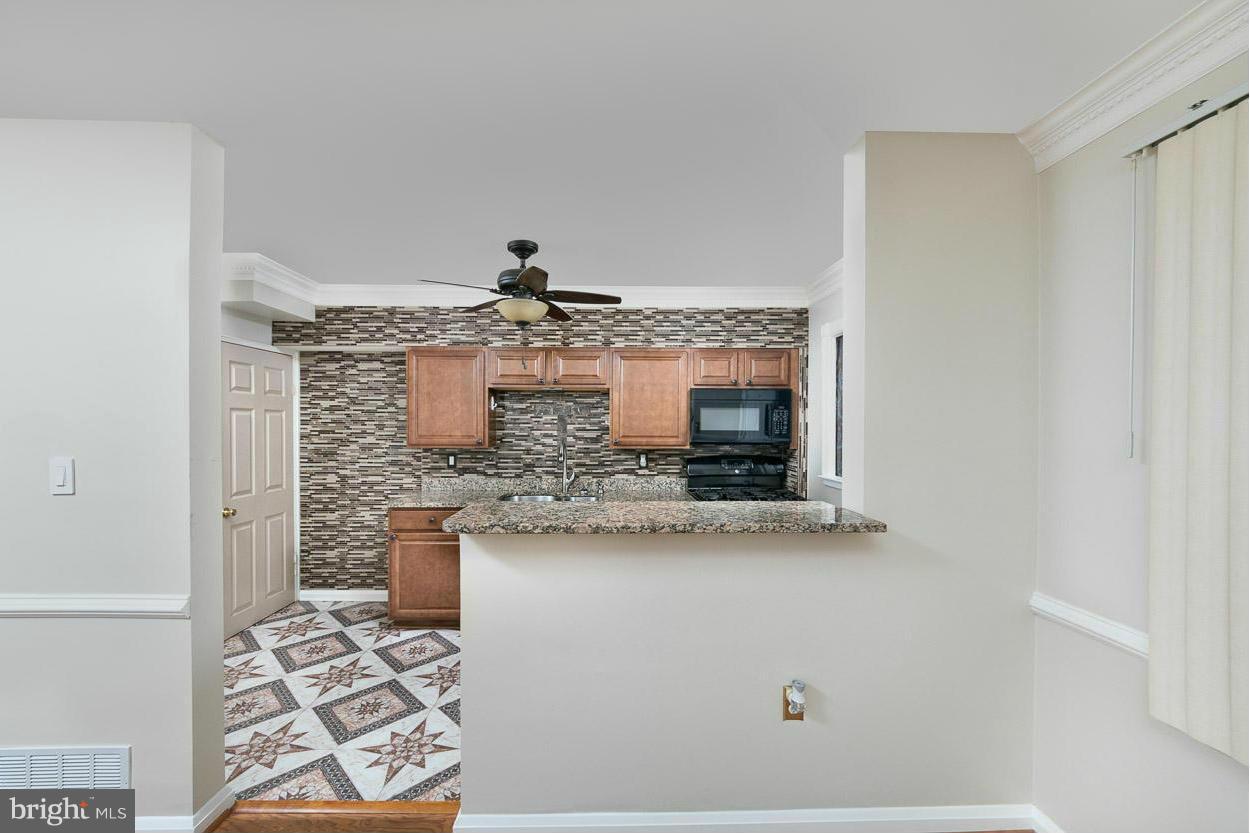 573 Brisbane Road Baltimore, MD 21229 - Photo 3 of 30 a bathroom with a granite countertop sink and a mirror