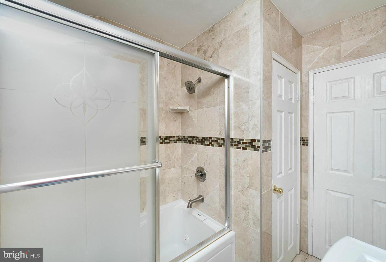 573 Brisbane Road Baltimore, MD 21229 - Photo 22 of 30 a bathroom with a shower and a glass door