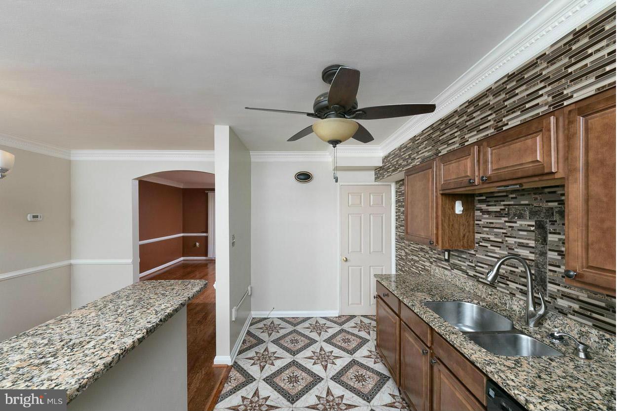 573 Brisbane Road Baltimore, MD 21229 - Photo 5 of 30 a kitchen with granite countertop a sink and stove