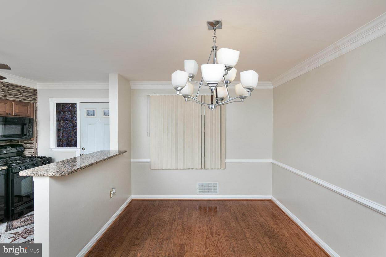 573 Brisbane Road Baltimore, MD 21229 - Photo 8 of 30 a view of a room with wooden floor and chandelier