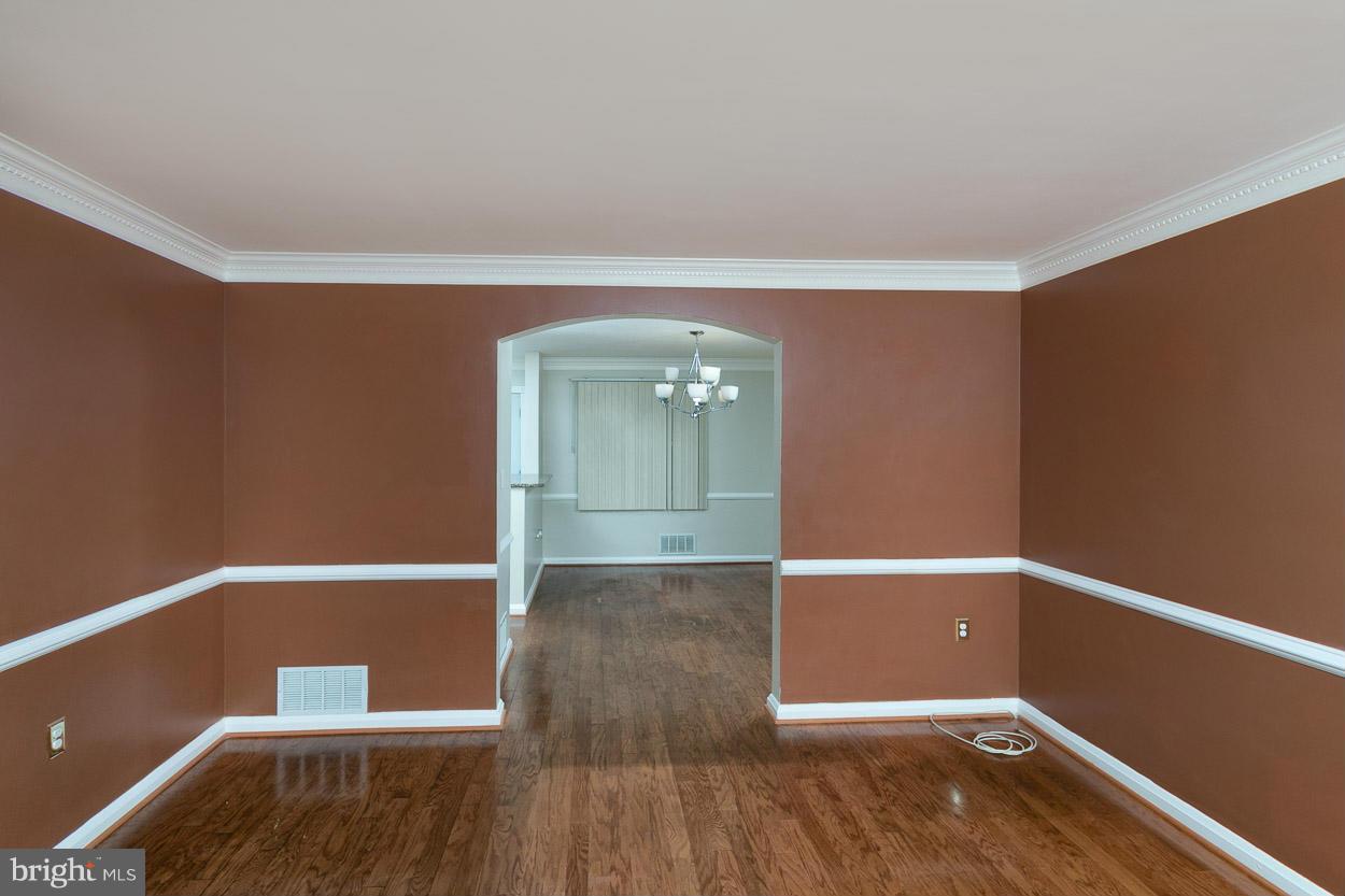573 Brisbane Road Baltimore, MD 21229 - Photo 9 of 30 wooden floor in an empty room