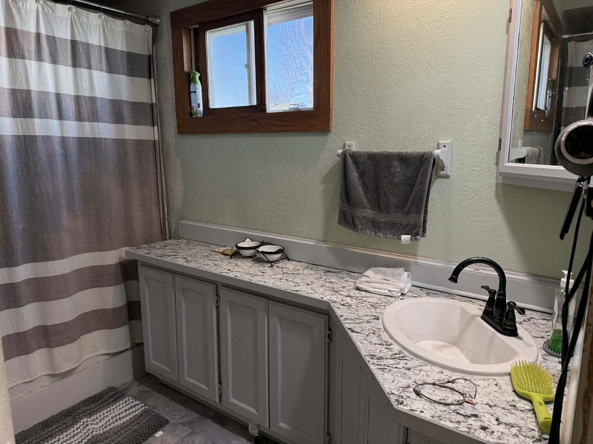 505 East Main Street Durand, IL 61024 - Photo 13 of 18 a bathroom with a granite countertop sink and a mirror