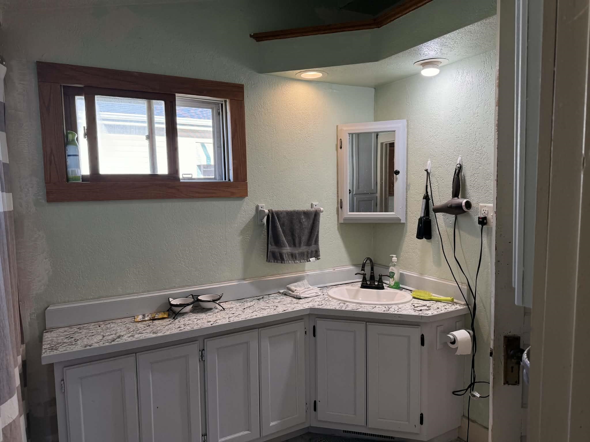 505 East Main Street Durand, IL 61024 - Photo 14 of 18 a bathroom with a granite countertop sink and a mirror