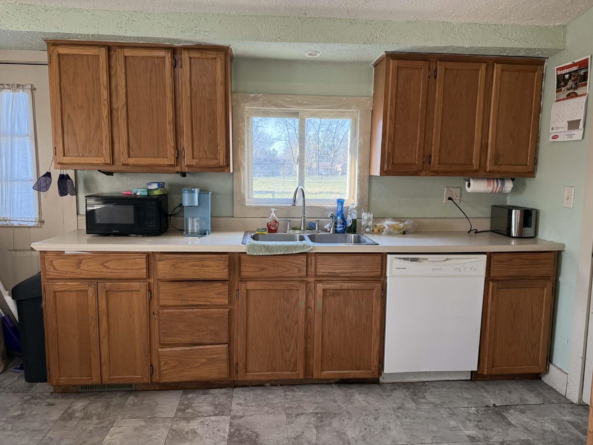 505 East Main Street Durand, IL 61024 - Photo 8 of 18 a kitchen with stainless steel appliances granite countertop wooden cabinets a sink and a window