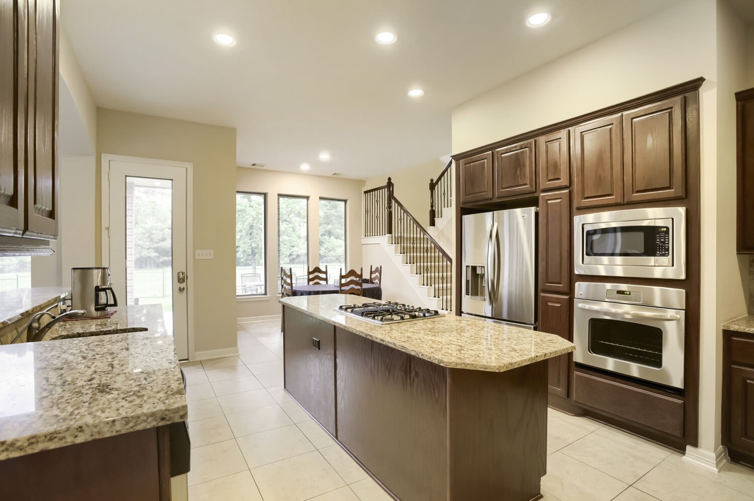 11 Spotted Lily Way The Woodlands, TX 77354 - Photo 12 of 30 a kitchen with stainless steel appliances granite countertop a sink stove and refrigerator
