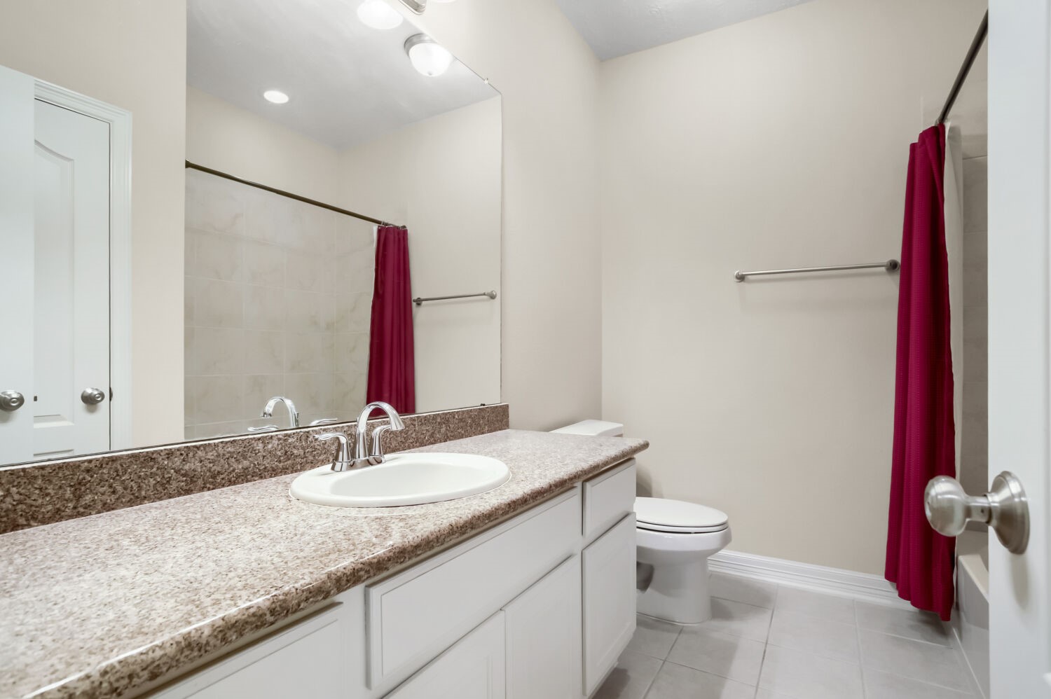 11 Spotted Lily Way The Woodlands, TX 77354 - Photo 24 of 30 a bathroom with a granite countertop sink a toilet and a mirror