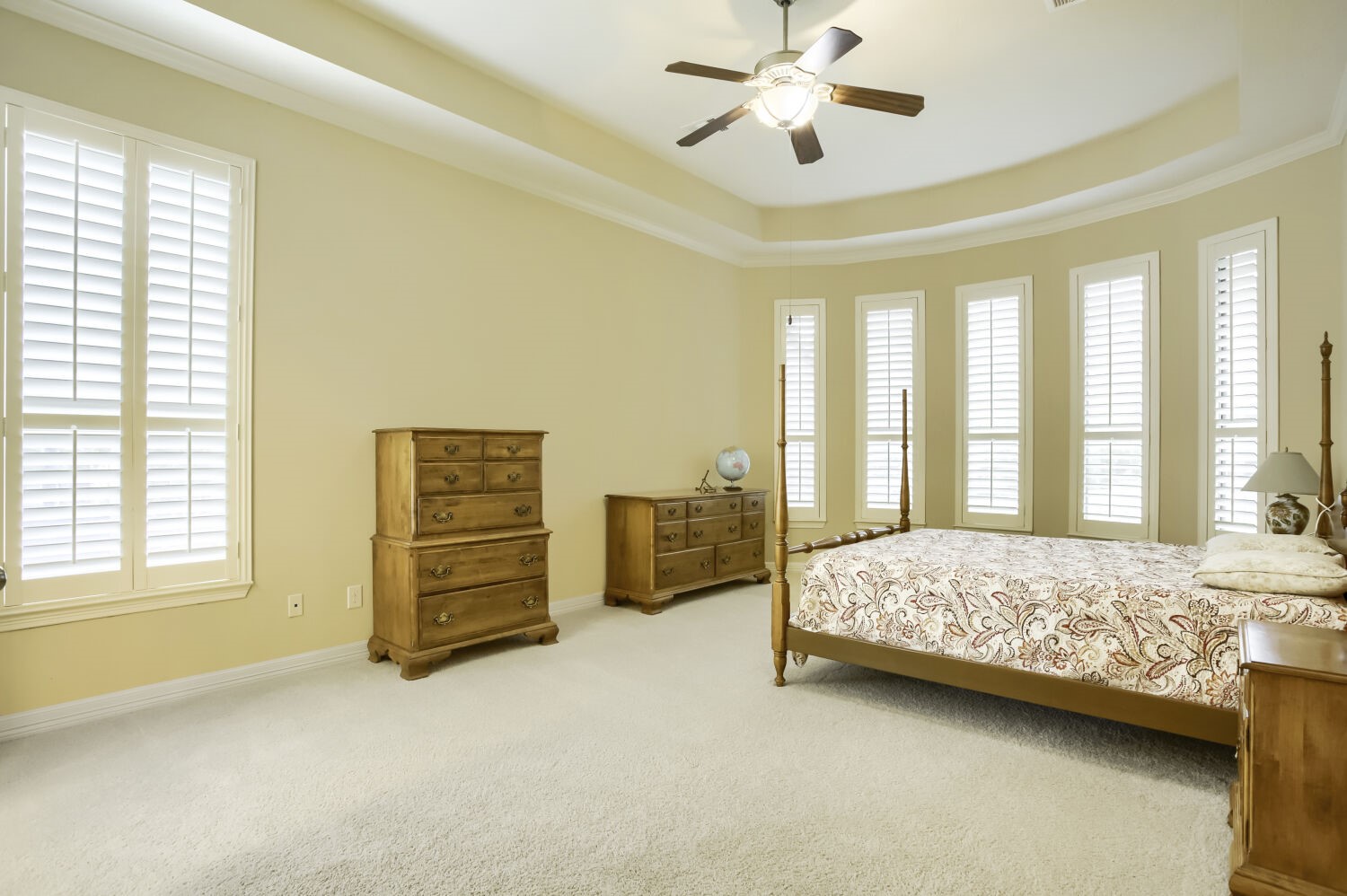 11 Spotted Lily Way The Woodlands, TX 77354 - Photo 25 of 30 a bedroom with a bed and a chandelier