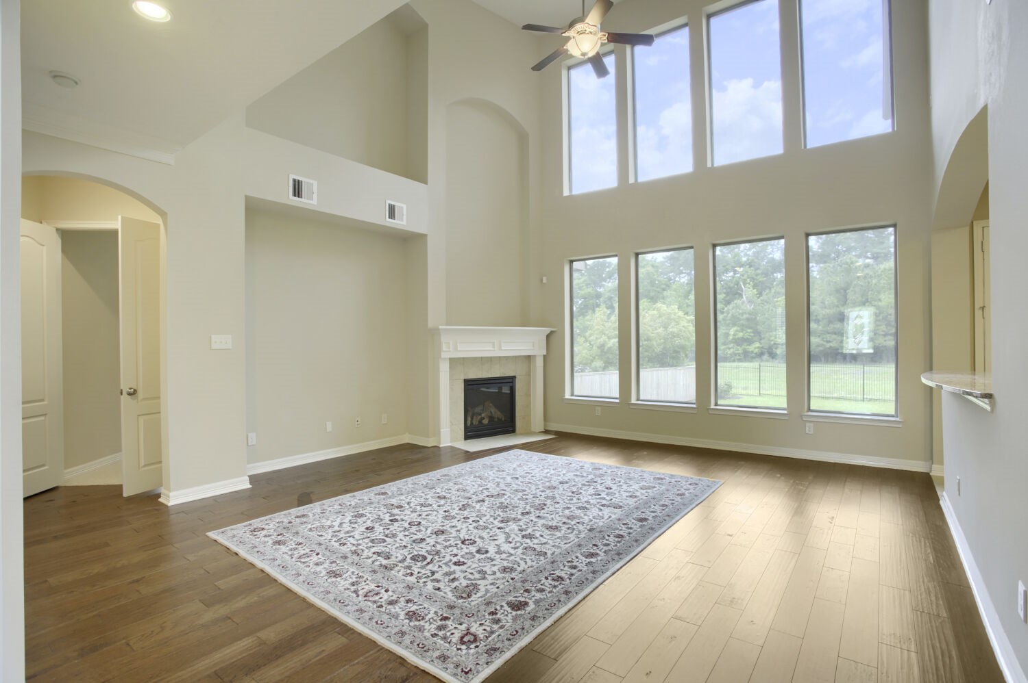 11 Spotted Lily Way The Woodlands, TX 77354 - Photo 8 of 30 a view of an empty room with wooden floor and a fireplace