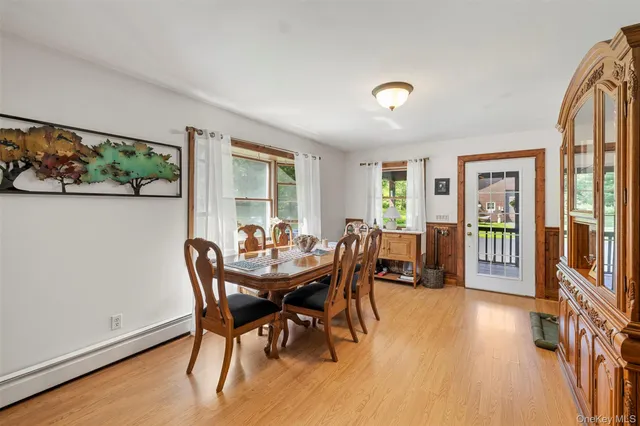 a kitchen with stainless steel appliances granite countertop a stove a refrigerator a sink a stove a dining table and chairs