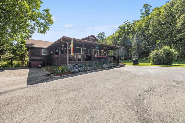 front view of a house with a yard and an trees