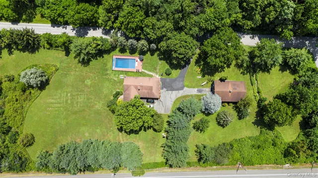 an aerial view of a house with a yard basket ball court and outdoor seating