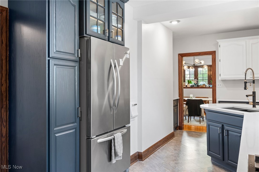 2213 Coventry Road Cleveland, OH 44118 - Photo 22 of 46 Kitchen featuring sink, white cabinets, stainless steel refrigerator, light hardwood / wood-style flooring, and blue cabinetry