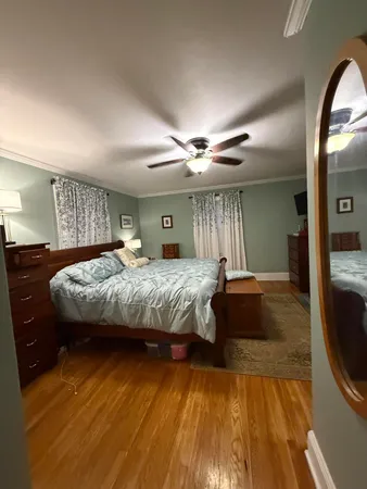 a bedroom with a large bed and a chandelier